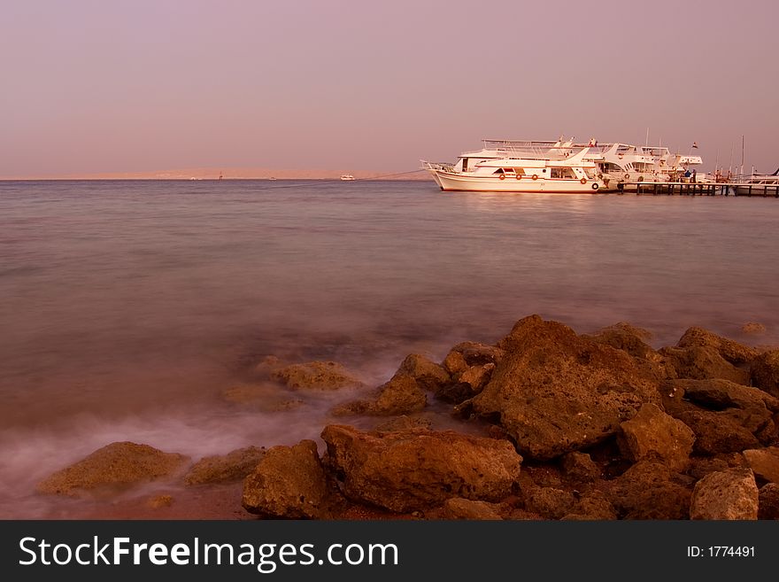 Picture of a sunset with a yacht on the background. Picture of a sunset with a yacht on the background