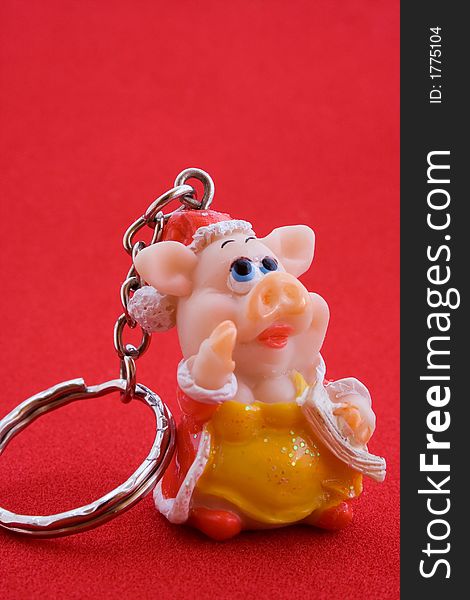 Trinket In The Form Of Pig On Red