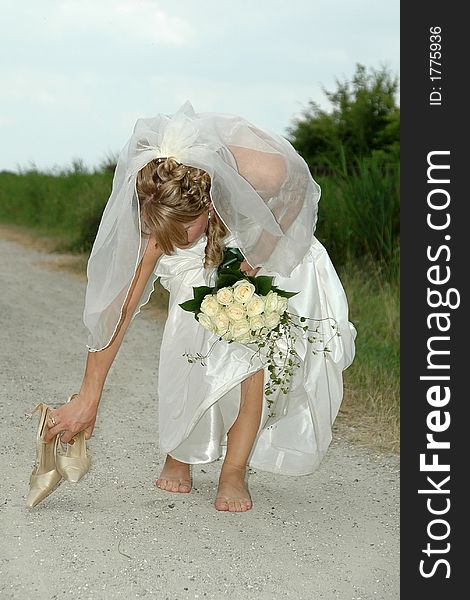 Bride is picking up her shoes