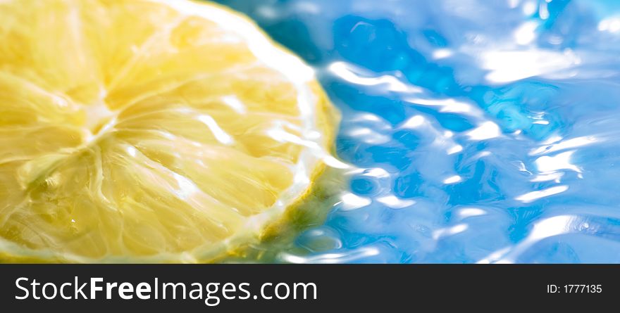 Lemon fruit on the water with blue background. Lemon fruit on the water with blue background