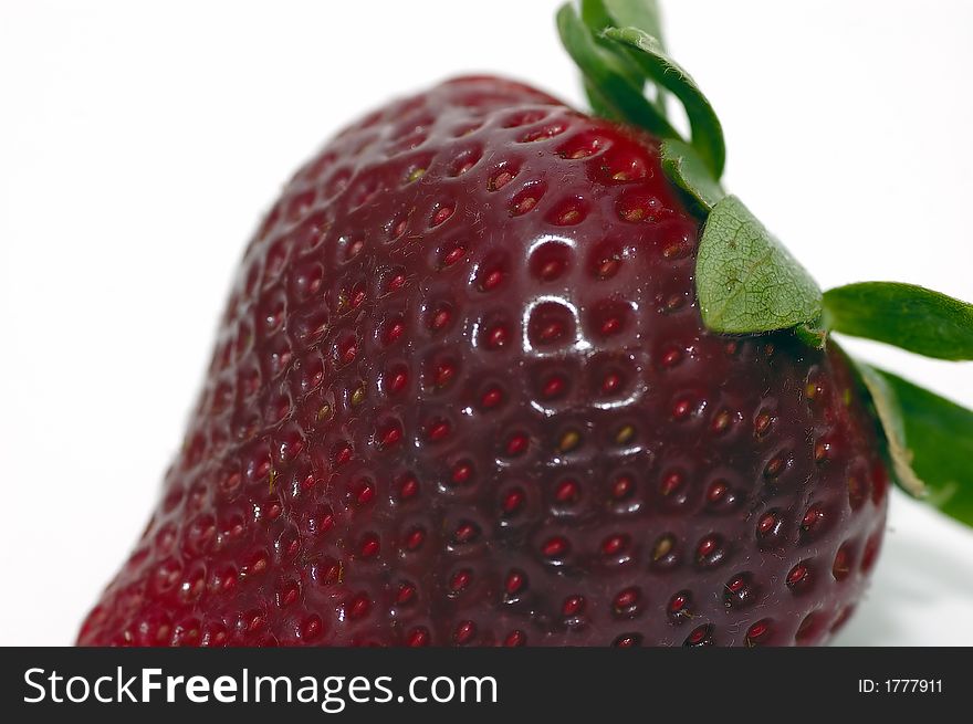 A closeup shot of a strawberry isolated against a white background