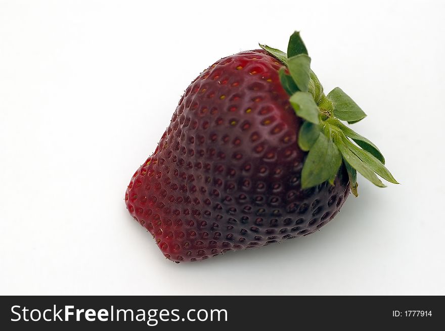 A closeup shot of a strawberry isolated against a white background. A closeup shot of a strawberry isolated against a white background
