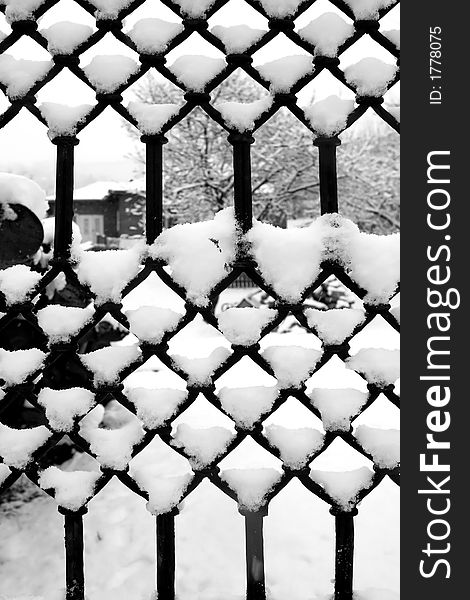 Iron fence texture covered by snow