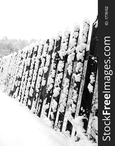 Winter fence detail covered by snow