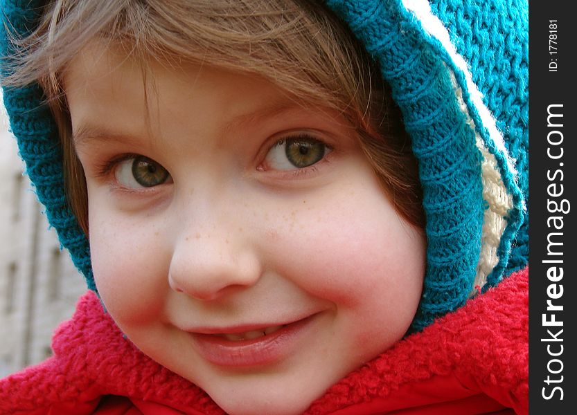 Little smiling girl wintertime outdoor portrait. Little smiling girl wintertime outdoor portrait