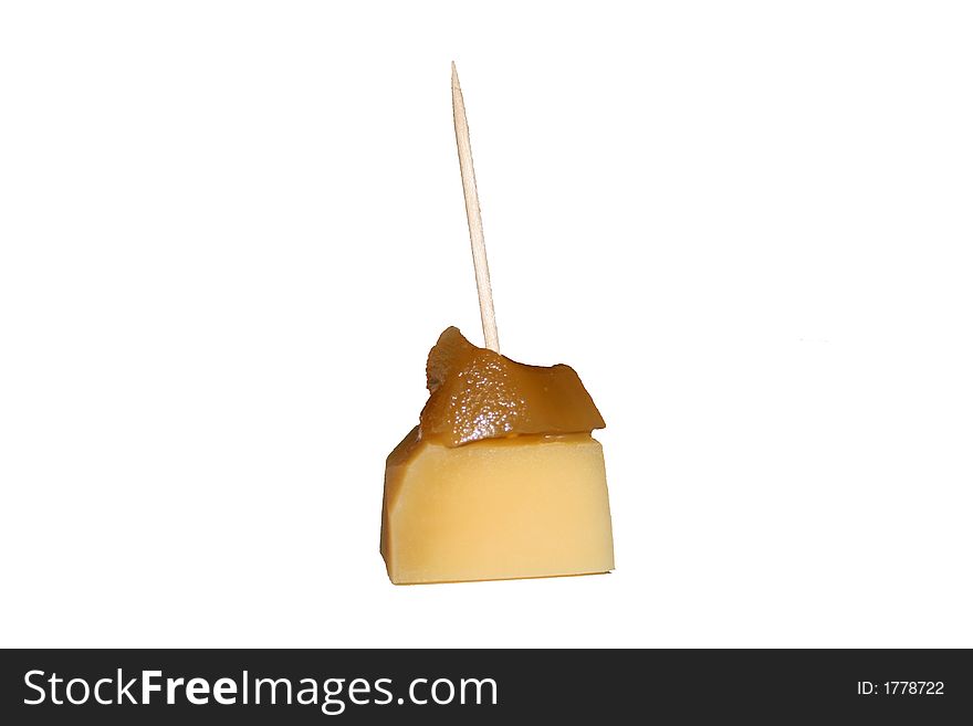 Cube of edam cheese with ginger on top. Cube of edam cheese with ginger on top