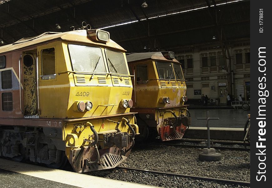 Two old, yellow railway locomotives at Hua Lampong railway station in Bangkok, Thailand. Two old, yellow railway locomotives at Hua Lampong railway station in Bangkok, Thailand