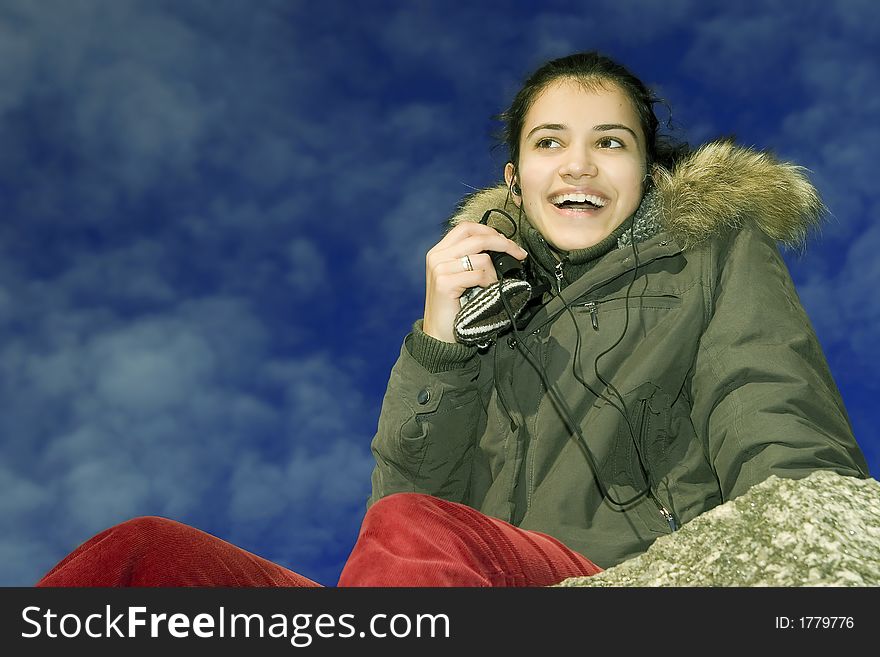 Young smiling girl listening mp3 player. Young smiling girl listening mp3 player