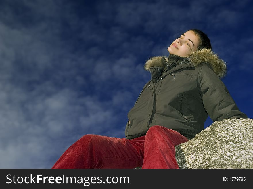 Relaxing girl on maountain on blue sky