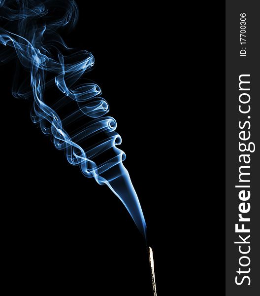 Rising blue smoke on black background