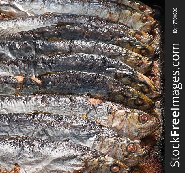 Roasted fish in baking tray .