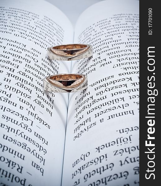 Two wedding rings on a book