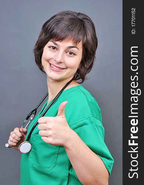 Attractive lady doctor whit thumb up
