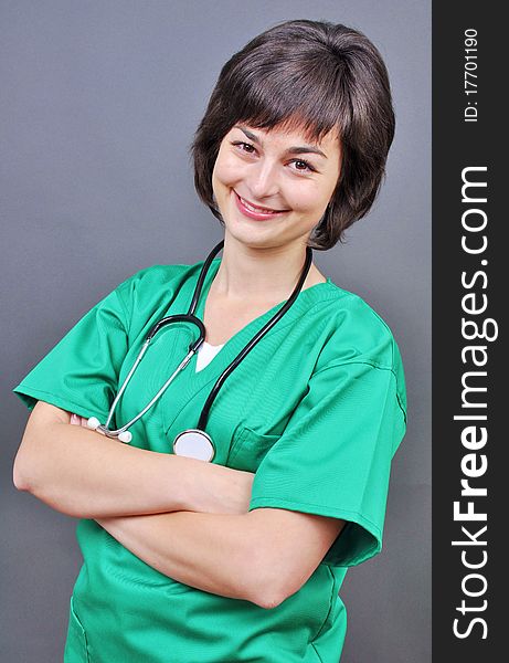 Attractive lady doctor on a over gray background