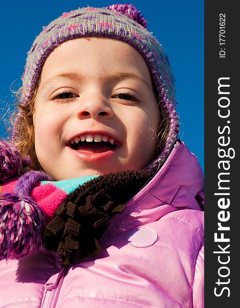 Young caucasian girl dressed up for winter, smiling. Young caucasian girl dressed up for winter, smiling