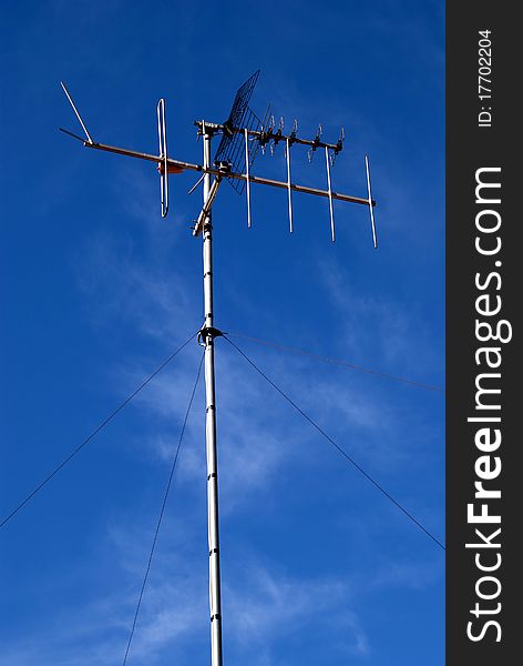 Television antenna mounted on a mast on a roof