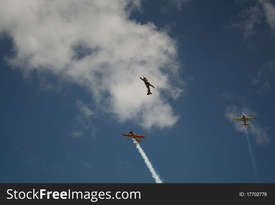 Three airplanes performing a stunt