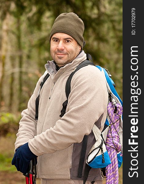 Hiker looking on front of him with backpack and gear