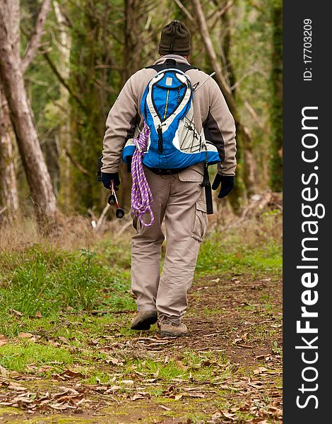 Hiker walking a trail, with backpack and gear
