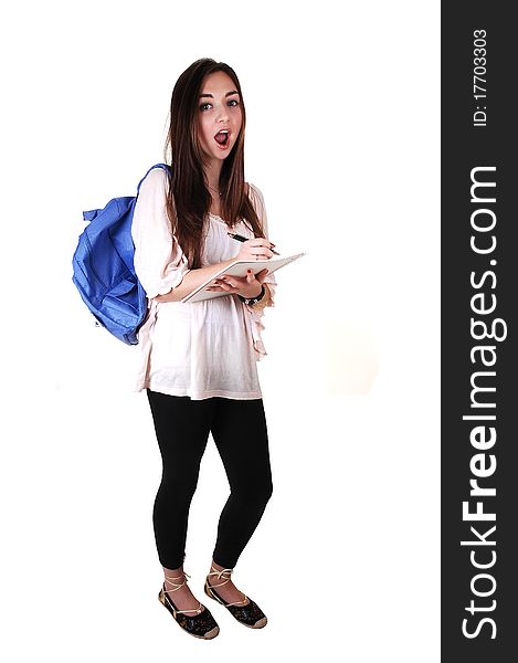 An surprised teenager with a blue backpack over her shoulder in an beige blouse and black tights, with a notebook in her hand, over white. An surprised teenager with a blue backpack over her shoulder in an beige blouse and black tights, with a notebook in her hand, over white.