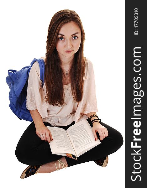 An surprised teenager with a blue backpack over her shoulder in an beige blouse and black tights, with a notebook in her hand, over white. An surprised teenager with a blue backpack over her shoulder in an beige blouse and black tights, with a notebook in her hand, over white.