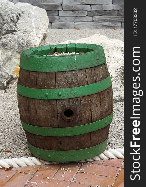 Green wood Barrel, stones on the background