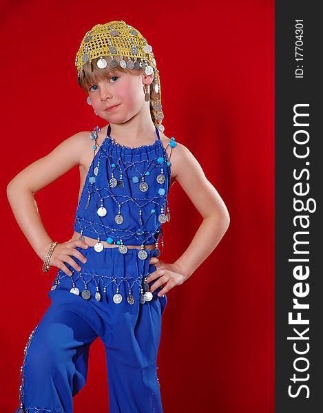 Little girl in oriental costume on a red background