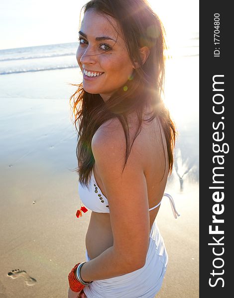 Brunette female model on beach at sunset. Brunette female model on beach at sunset