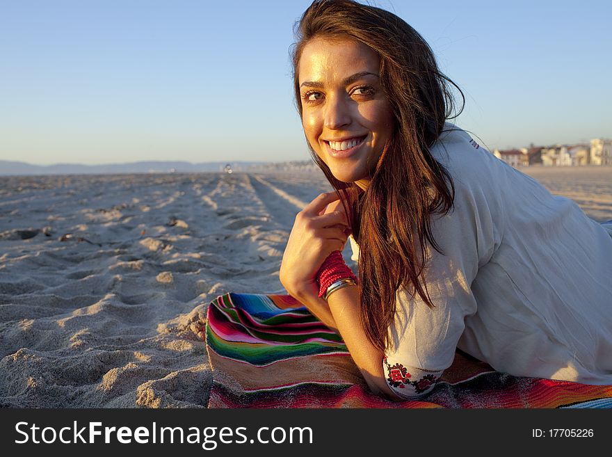 Brunette female model on beach at sunset. Brunette female model on beach at sunset