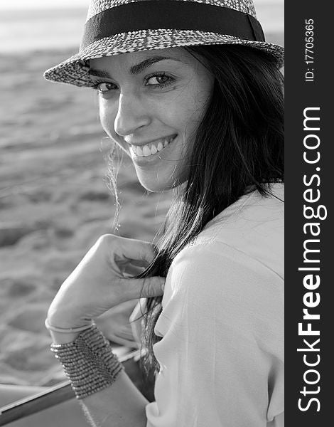 Brunette female model on beach at sunset in black and white. Brunette female model on beach at sunset in black and white