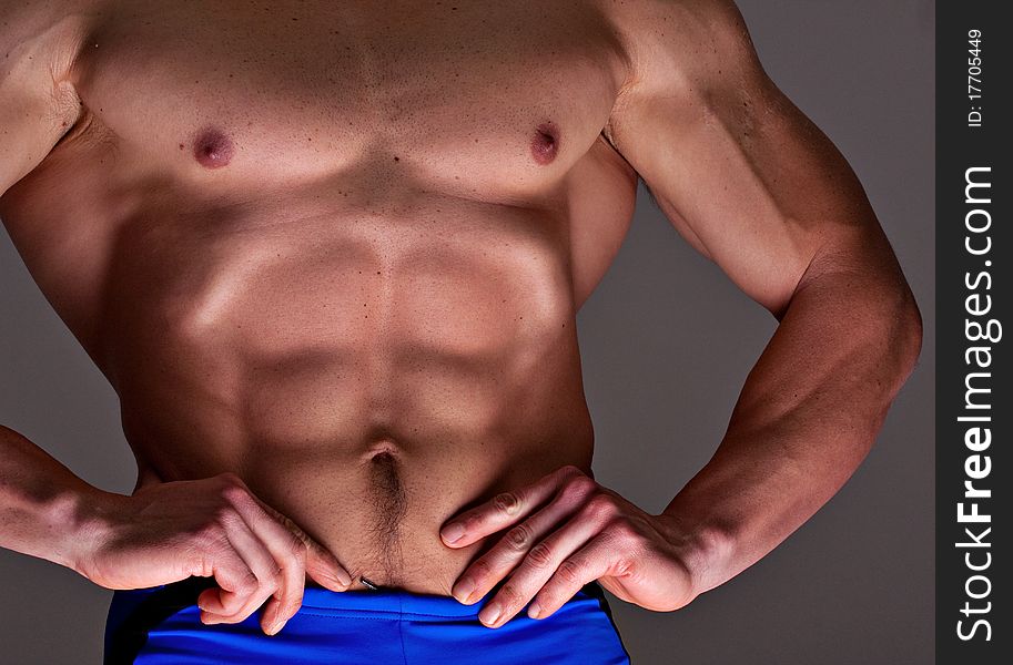 Muscular male torso with directional lighting to bring out muscular detail