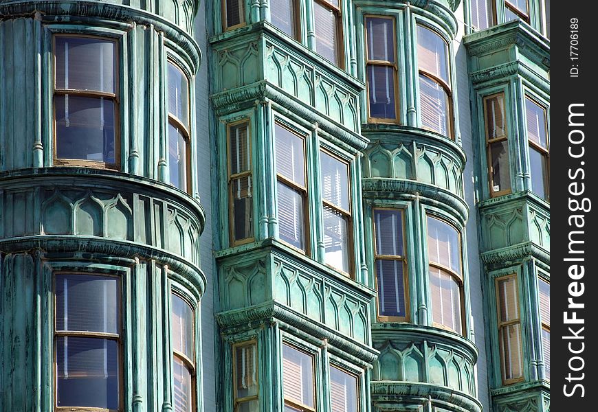 Facade in San Francisco with round and square bay windows and wood blinds in the windows. Facade in San Francisco with round and square bay windows and wood blinds in the windows