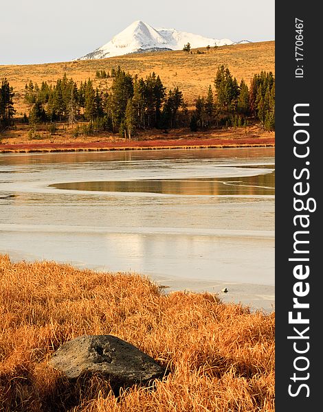 Snow Capped Mountain Behind Ice Covered Lake