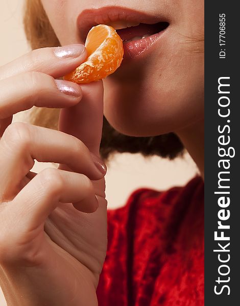 Girl eating a mandarin closeup. Girl eating a mandarin closeup