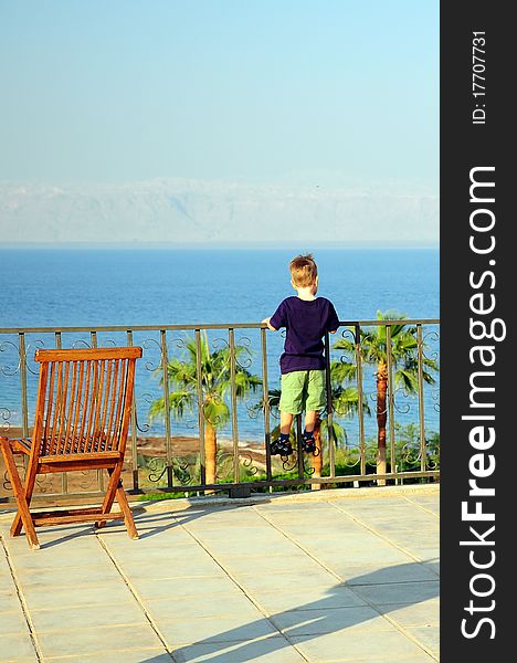 Kid climbed fence of a balcony. Kid climbed fence of a balcony