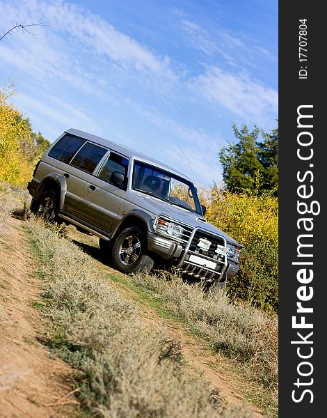 Gray jeep standing on the road on rural landscape. Gray jeep standing on the road on rural landscape