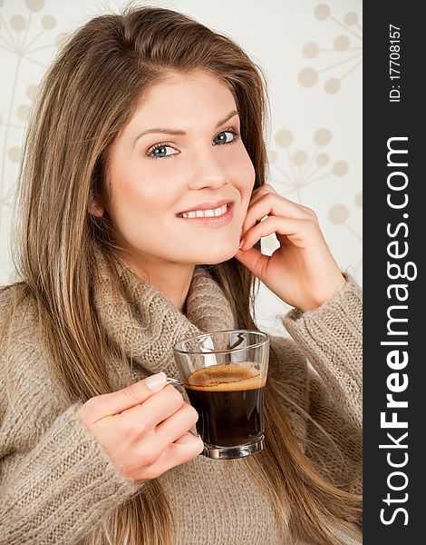Beauty, young girl holding a cup of coffee and smiling