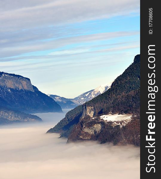 View over a valley of clouds filling. View over a valley of clouds filling