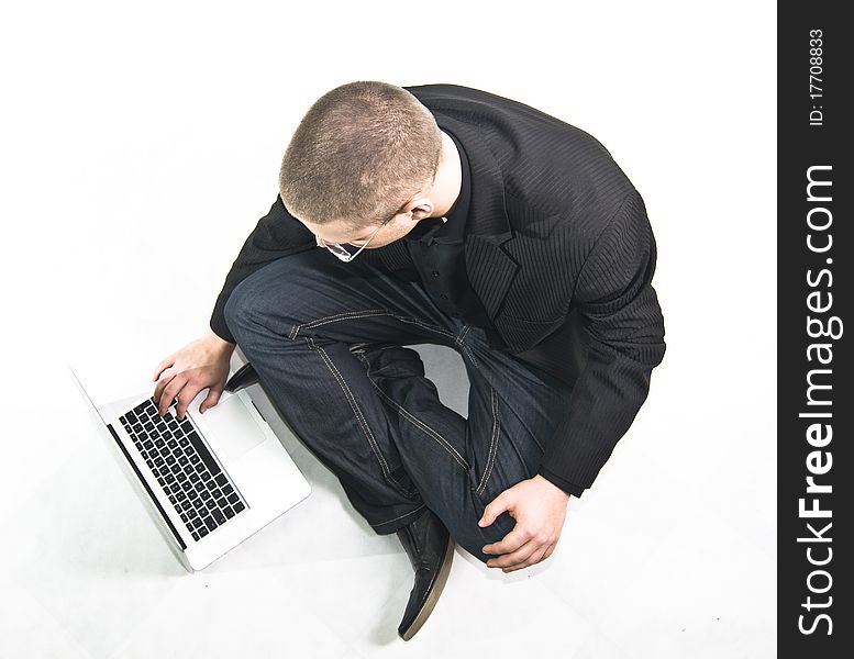 Young businessman in suit sitting on the floor