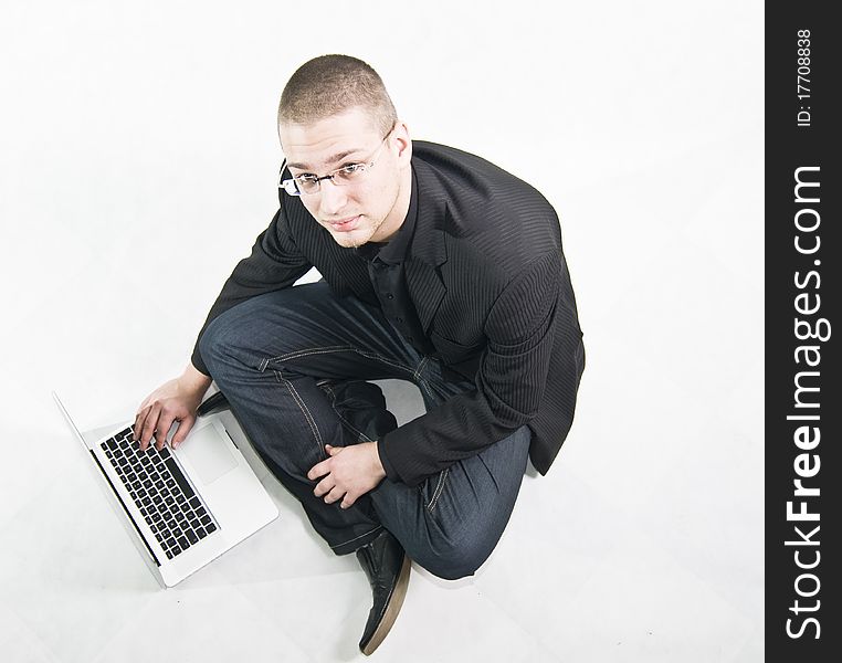 Young businessman in suit sitting on the floor