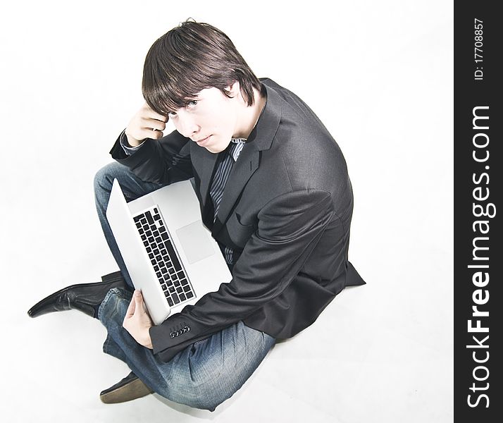 Young businessman in suit sitting on the floor