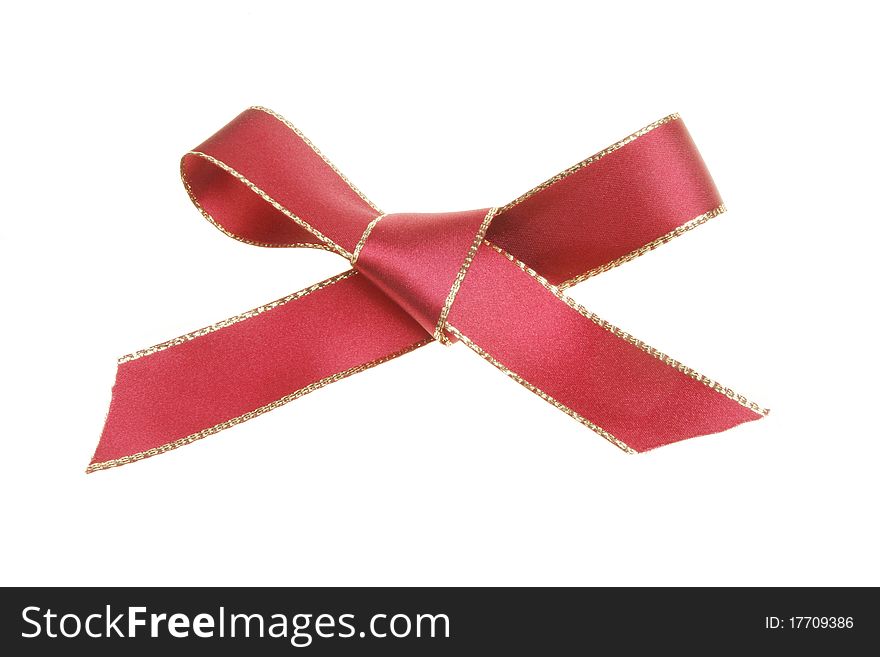 Gold edged red ribbon tied in a bow isolated on white. Gold edged red ribbon tied in a bow isolated on white