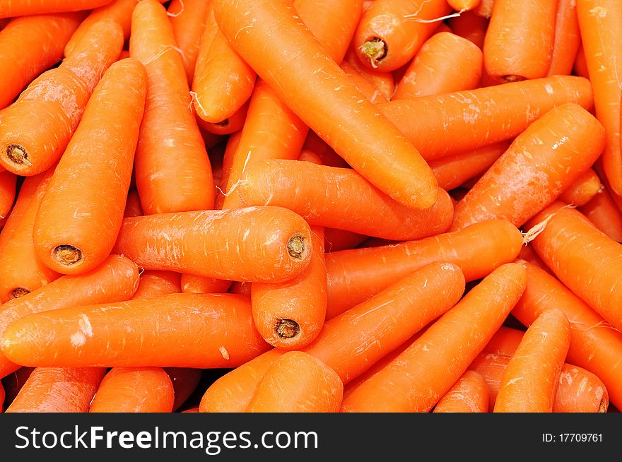 Arrangement of Carrots At A Market Stall Forming A Background