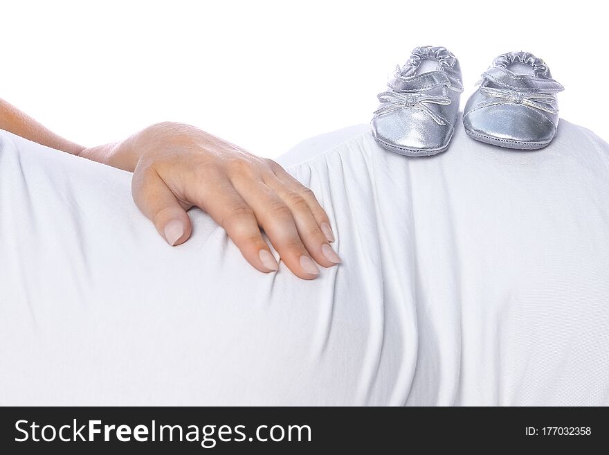A Happy pregnant girl lies on white background