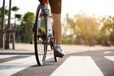 Athlete Woman Cyclist Legs Riding Mountain Bike On The Road In The Morning Stock Photos