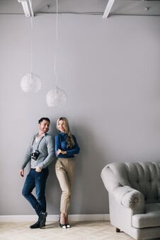 Handsome Man With A Camera And A Woman By The Wall Far Shot Stock Images