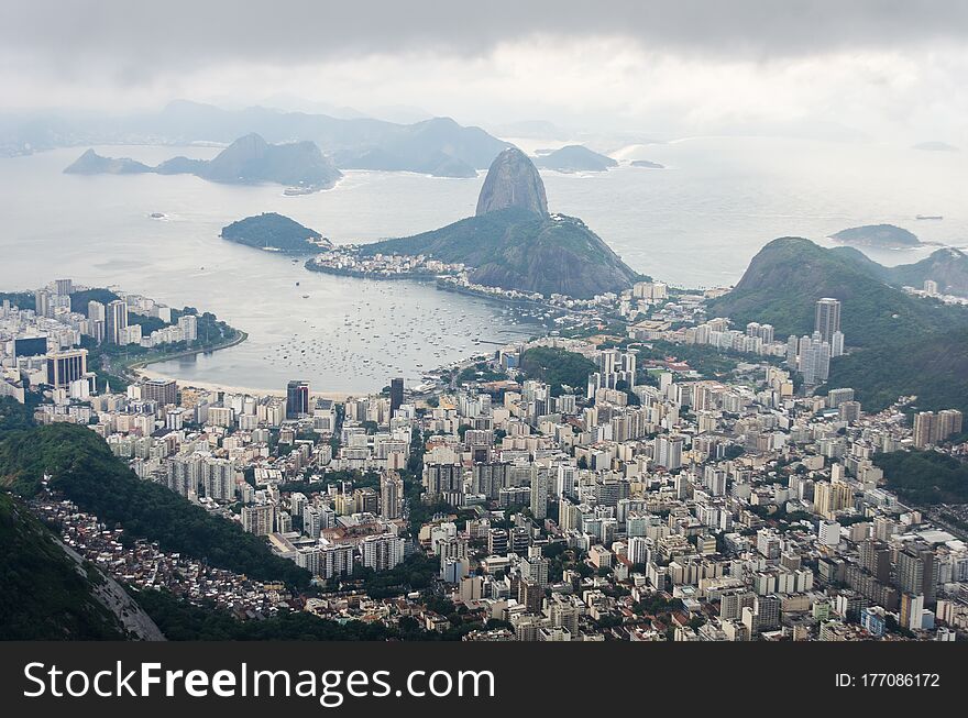 View of Rio de Janeiro from the Christ The Redeemer statue, with the Sugarloaf Mountain at the end of Botafogo Bay. View of Rio de Janeiro from the Christ The Redeemer statue, with the Sugarloaf Mountain at the end of Botafogo Bay