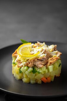 Salad With Canned Tuna And Vegetables In Culinary Ring On Black Plate. Royalty Free Stock Images