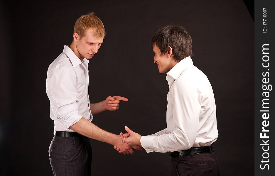 Portrait two adult man in business hand shake on black backdrop