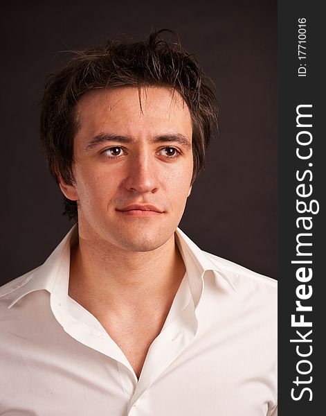 Portrait strong adult man with charming sight on a black backdrop